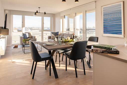a dining room and living room with a table and chairs