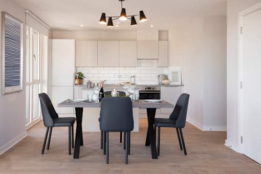 a kitchen and dining room with a table and chairs