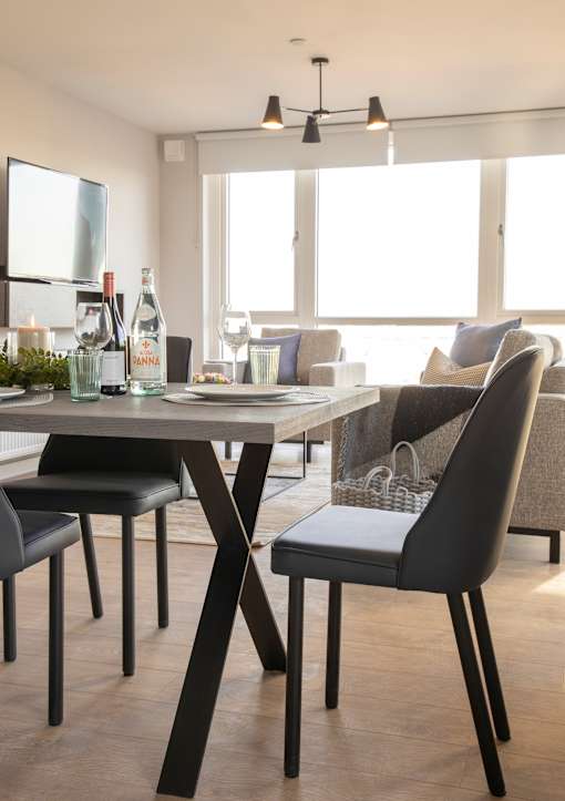 a dining room with a table and chairs and a living room