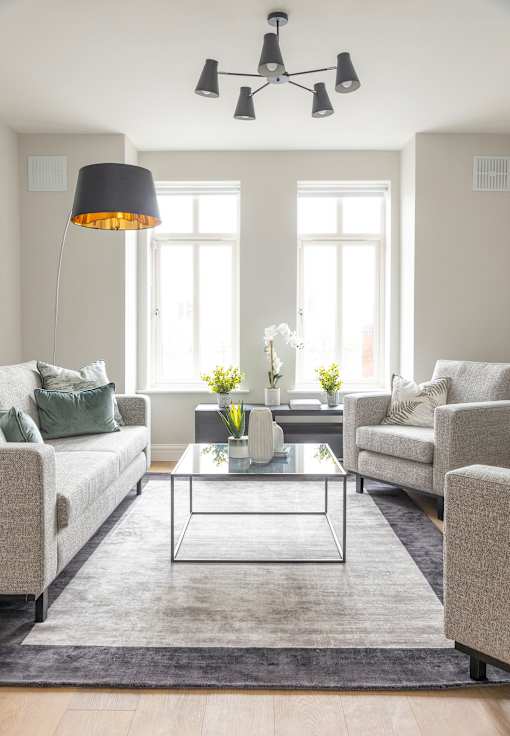 a living room with couches and chairs and a coffee table