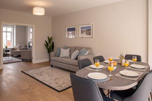 a living room with a dining table and a couch