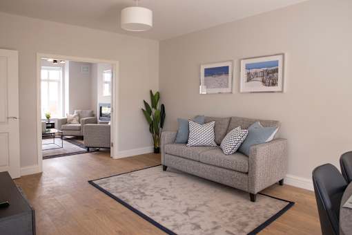 a living room with a couch and a rug