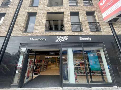 the front of a pharmacy store in a brick building