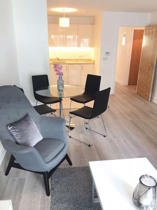 a living room with a couch and a chair and a table