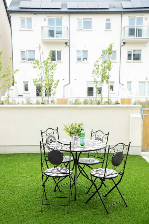 a small patio with a table and chairs on a balcony