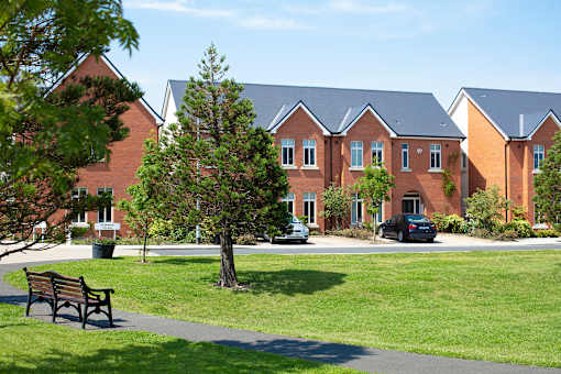 a bench in a park in front of a building