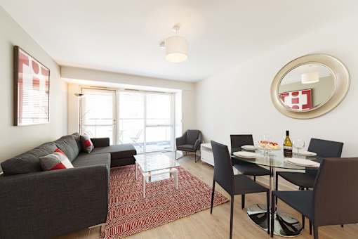 a living room with couches and a table and chairs