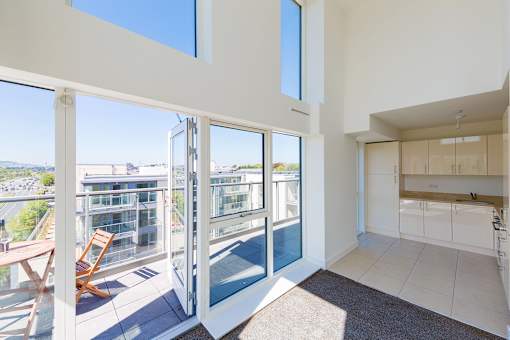 a view of the balcony from the living room of a house