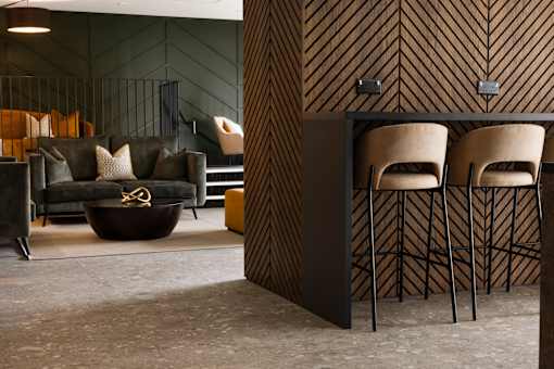 a living room with a couch and two chairs and a table
