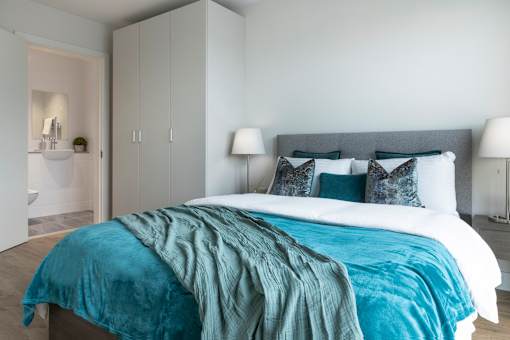 a bedroom with a bed and a ensuite bathroom