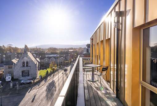 a balcony with a view of a city and a building