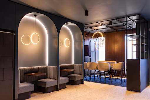 a rendering of a restaurant with arches and tables and chairs