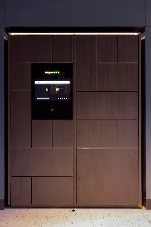 the elevators in the lobby of an office building with brown doors