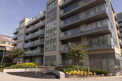 a large apartment building with a courtyard in front of it