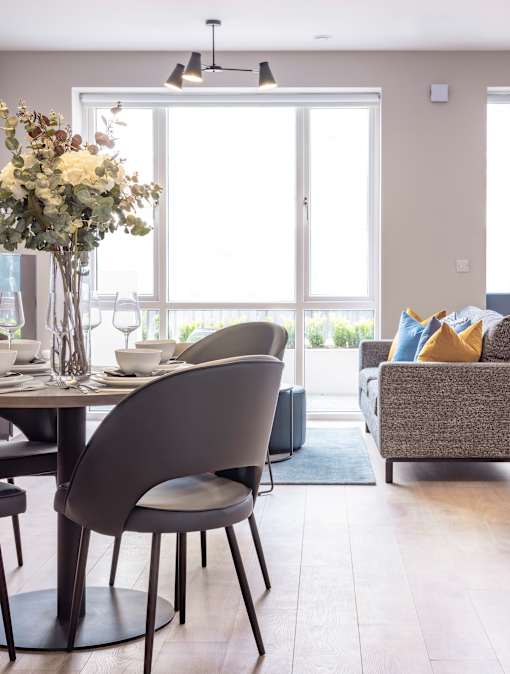 a dining room with a table and chairs and a large window