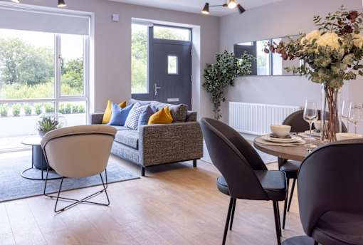a living room and dining room with a couch and a table and chairs