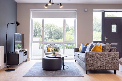 a living room with a couch and a coffee table and a television