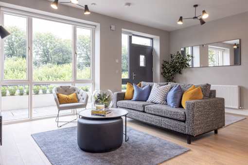 a living room with a gray couch and a coffee table