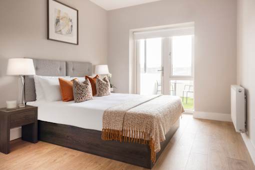 a bedroom with a large bed and a window
