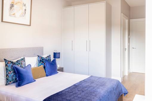 a bedroom with a large bed and white closets