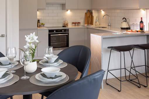 a kitchen and dining area with a table and chairs