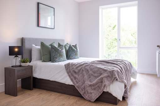 a bedroom with a bed and a large window