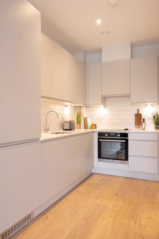 a kitchen with white cabinets and a stove and a sink