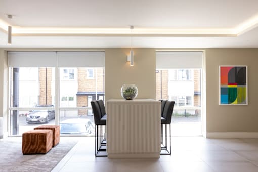 a dining room with a table and chairs and a large window