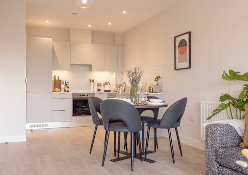 a kitchen and dining area with a table and chairs