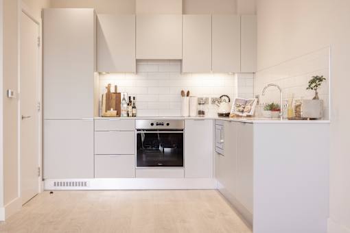 a white kitchen with white appliances and white cabinets