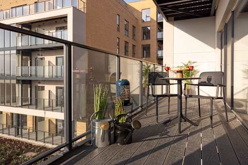 a patio with a table and chairs on a balcony