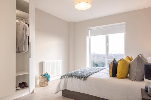 a bedroom with a bed and a closet and a window