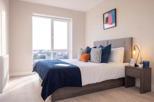 a bedroom with a large bed and a window