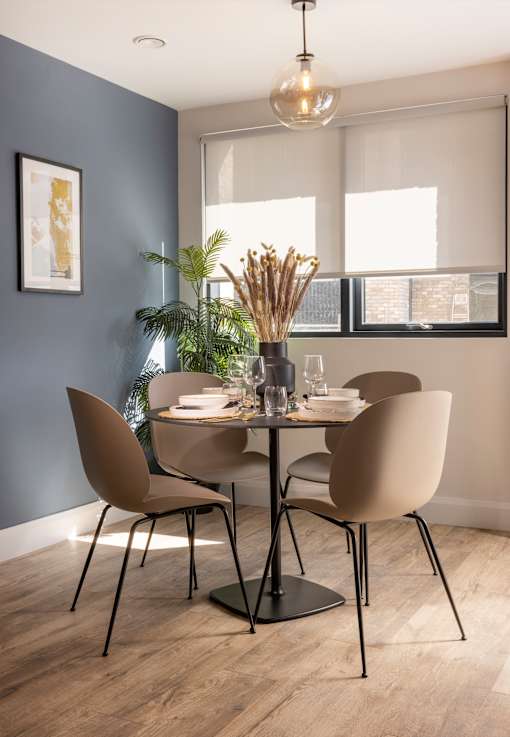 a dining room with a table and chairs and a window