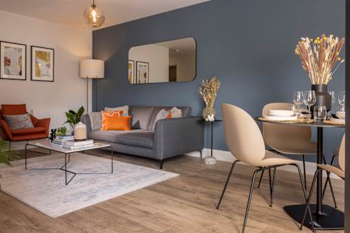 a living room and dining room with blue walls and a table and chairs