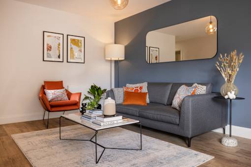 a living room with a couch and a coffee table and a mirror