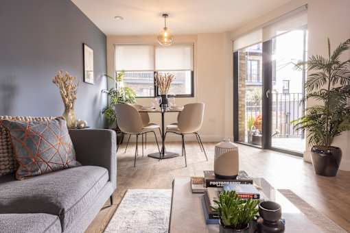 a living room with a couch and a table with chairs