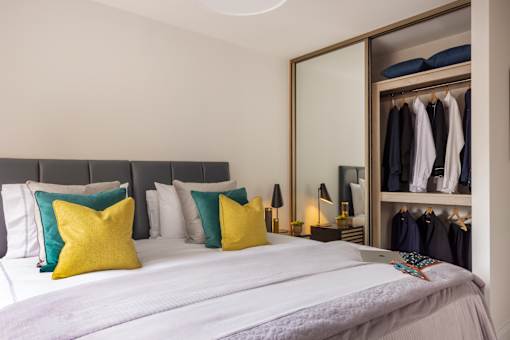 a bedroom with a large bed and a closet