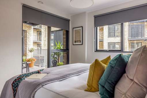 a bedroom with a large bed and a window