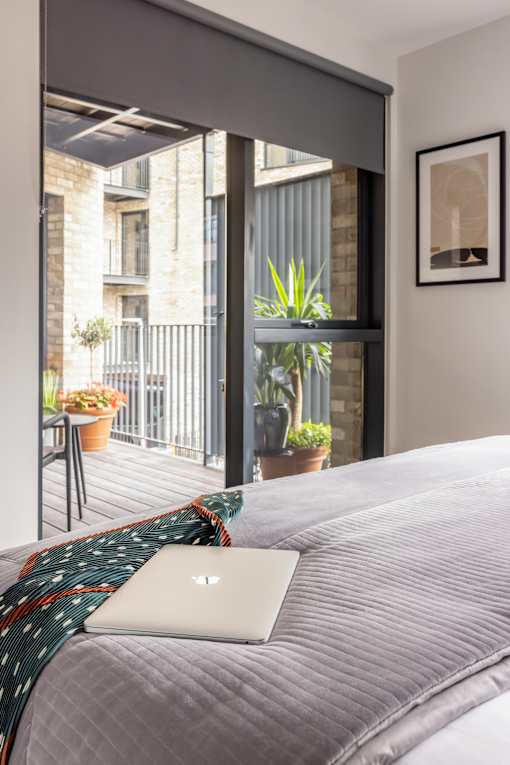 a bed with a laptop on top of it