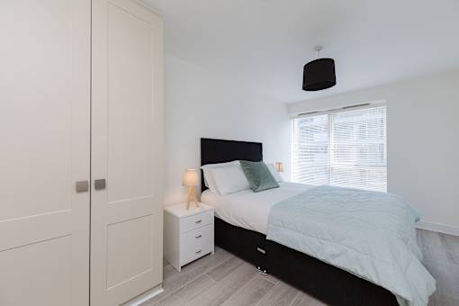 a bedroom with a bed and a closet