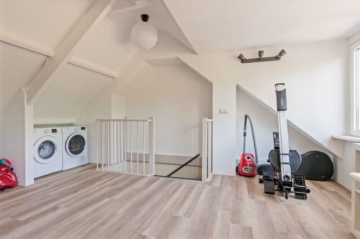 a white laundry room with a washing machine and a dryer