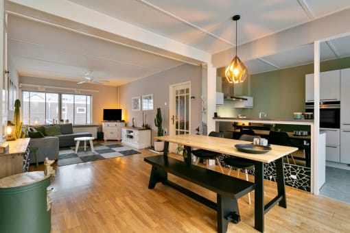 a living room with a dining room table and a kitchen