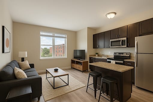 A modern kitchen with a refrigerator, microwave, and oven.