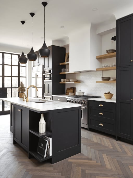 a kitchen with black cabinets and a white marble countertop