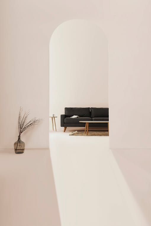 a living room with white walls and a black couch