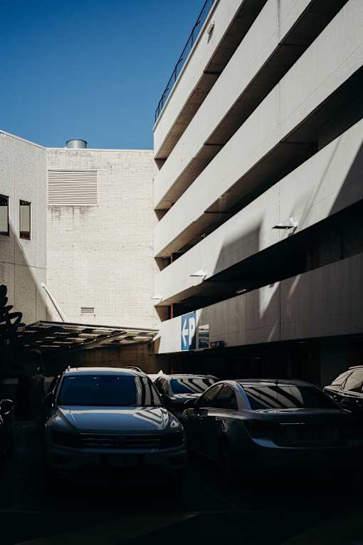 a parking lot full of cars in front of a building