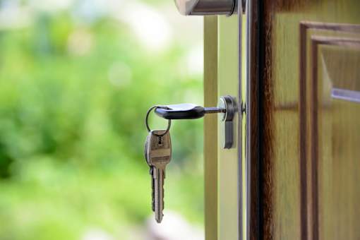A bunch of keys hanging from a door handle.