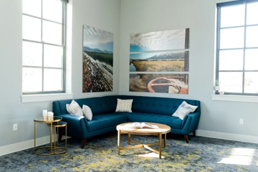 a living room with a blue couch and pictures on the wall