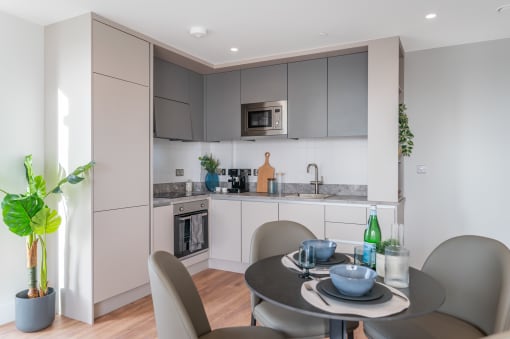 a kitchen and dining area with a table and chairs